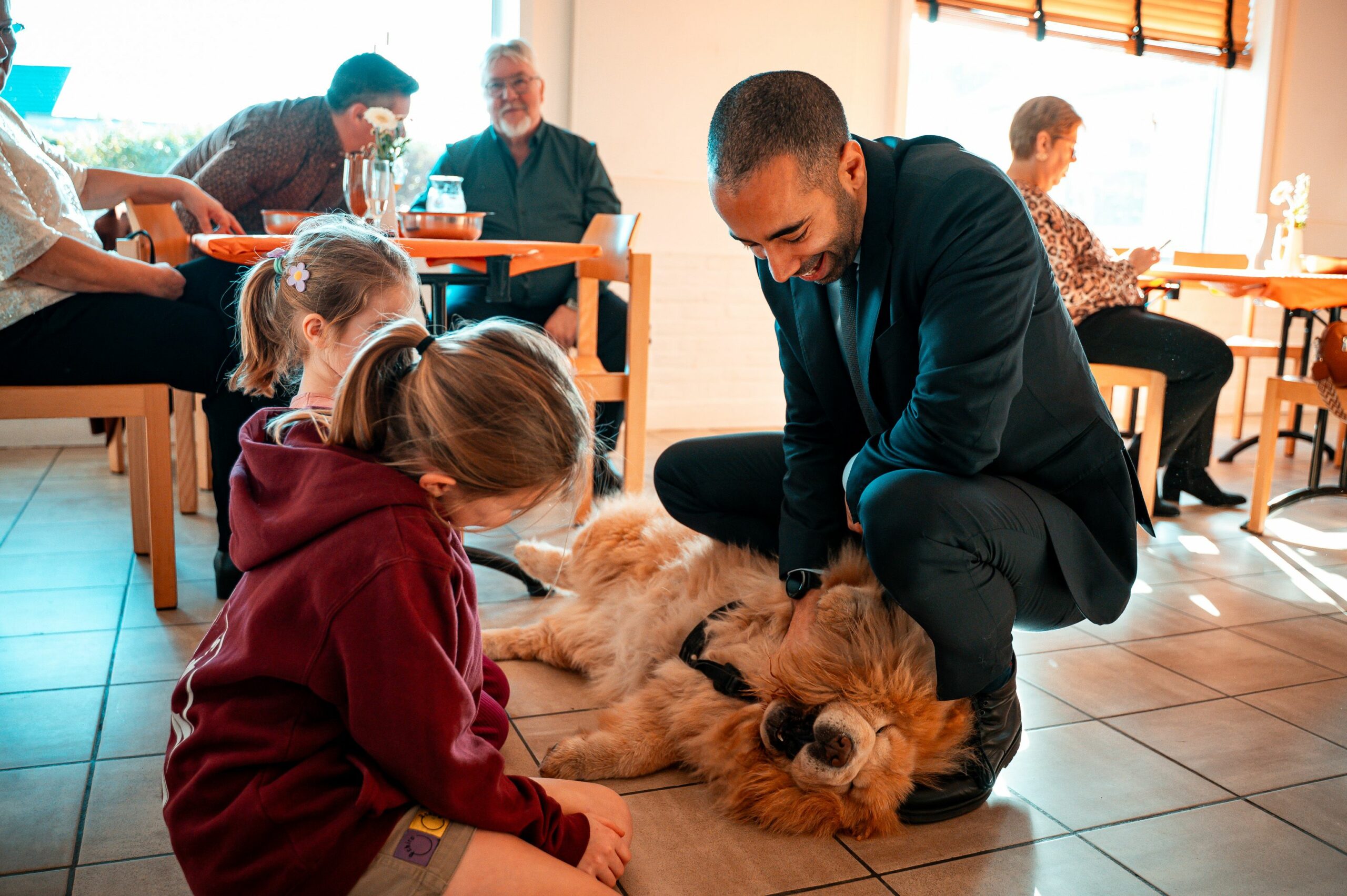 A heartwarming family scene with children and a dog in a cozy indoor setting.